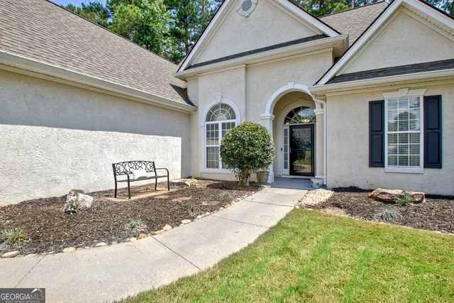 a front view of a house with garden