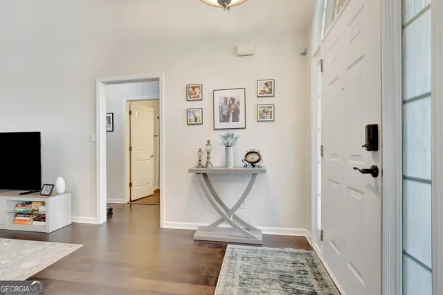 a view of a livingroom with wooden floor and a flat screen tv