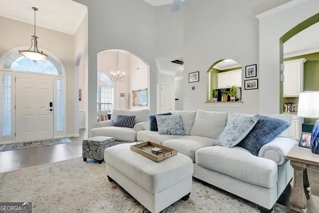 a living room with furniture and a mirror
