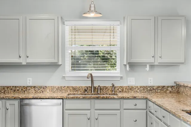 an empty room with a window and wooden floor