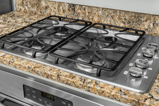 an empty room with windows and chandelier fan