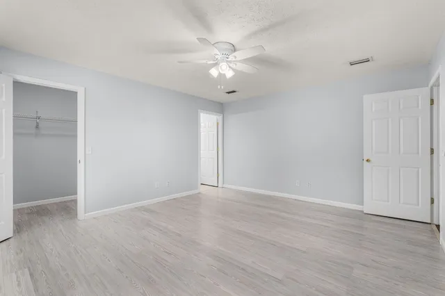 an empty room with fan and a ceiling fan