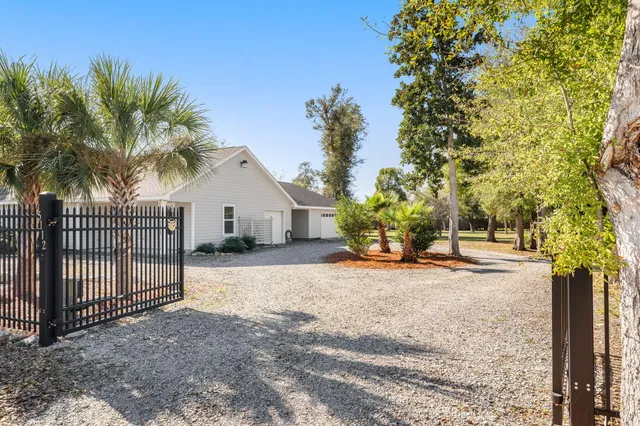 a view of a house with a yard and plant