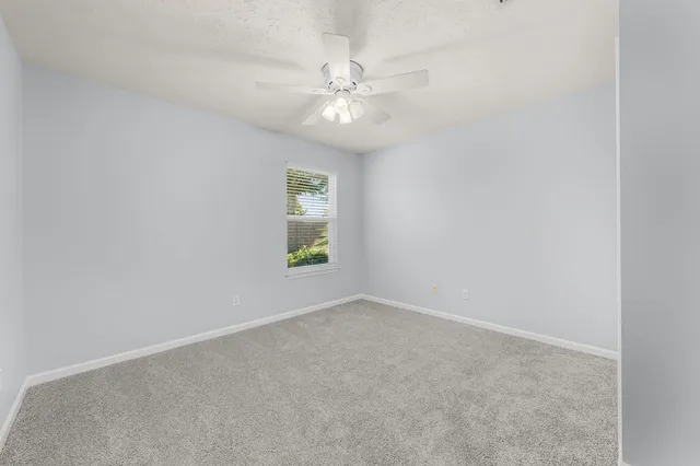 a view of a room with a large window and an outdoor space