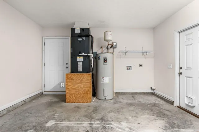 a backyard of a house with barbeque oven and a fire pit