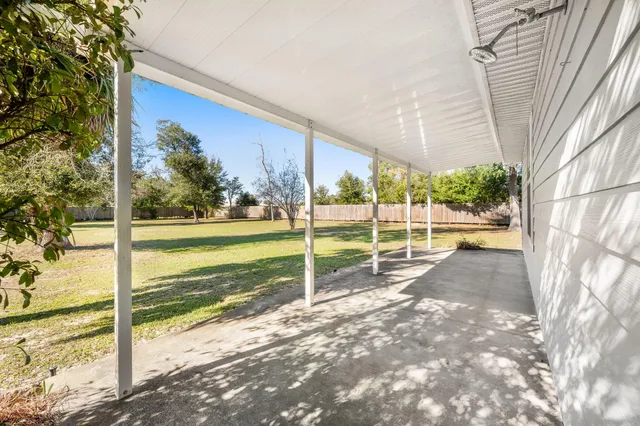 a view of a house with backyard and porch