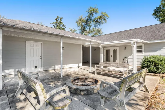 an aerial view of a house with yard swimming pool and outdoor seating