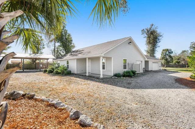 a front view of house with a garden