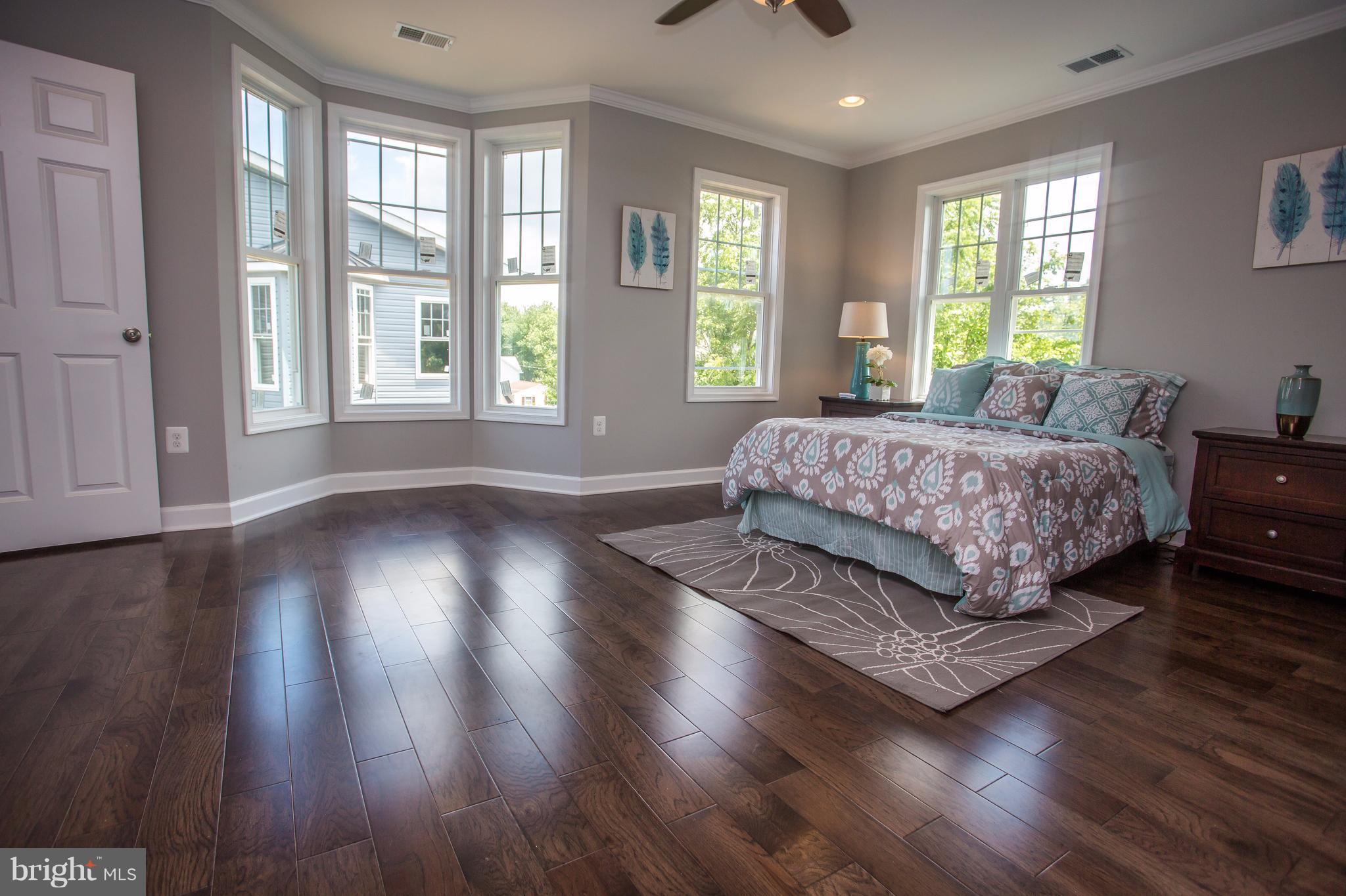 6445 First Street Alexandria, VA 22312 - Photo 13 of 28 a bedroom with a large bed and wooden floor