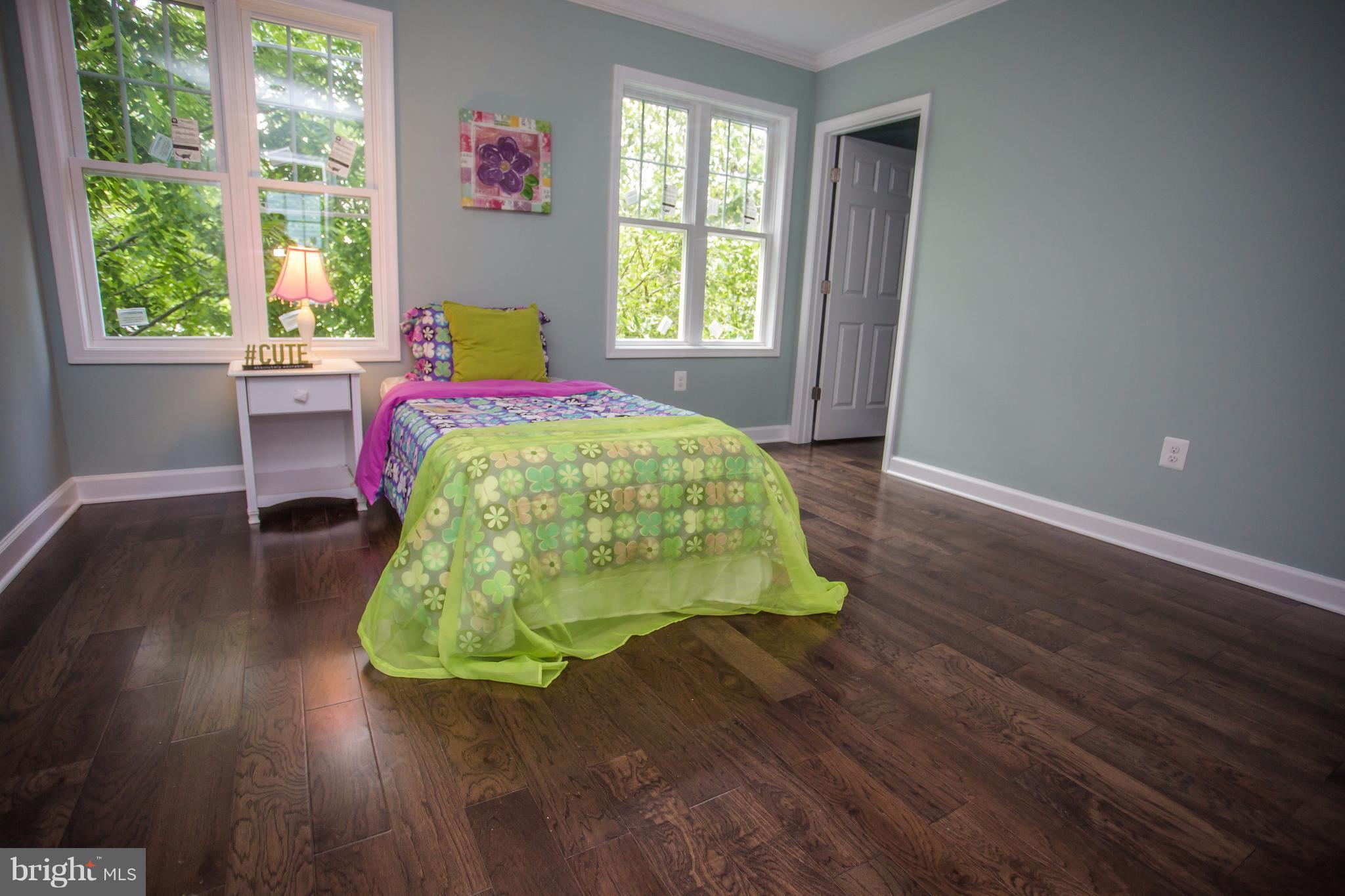 6445 First Street Alexandria, VA 22312 - Photo 15 of 28 a bed sitting in a bedroom next to a window