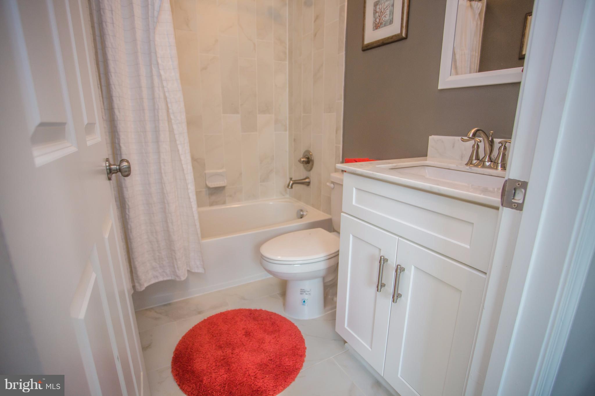 6445 First Street Alexandria, VA 22312 - Photo 17 of 28 a bathroom with a toilet a sink and a bathtub