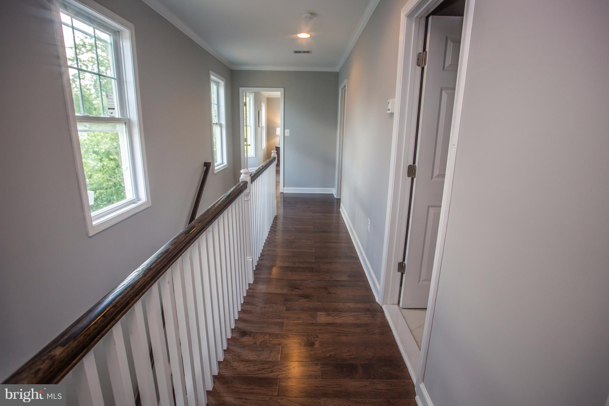 6445 First Street Alexandria, VA 22312 - Photo 25 of 28 a view of a hallway with wooden floor and staircase