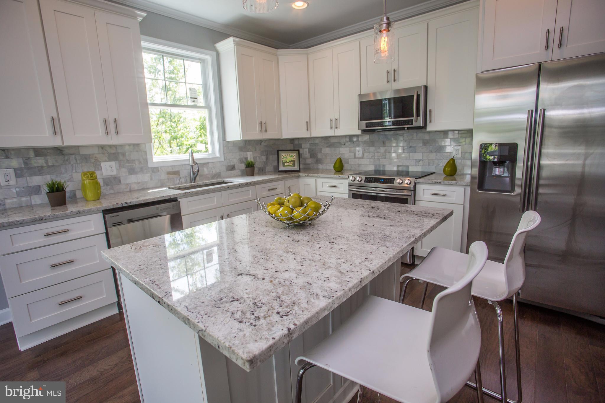 6445 First Street Alexandria, VA 22312 - Photo 4 of 28 a kitchen with granite countertop a sink chairs and cabinets