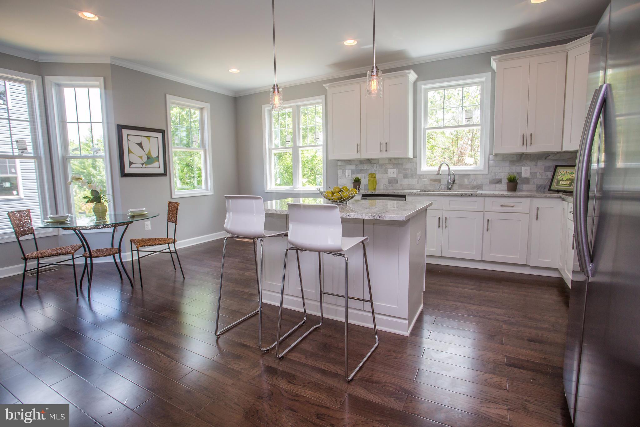 6445 First Street Alexandria, VA 22312 - Photo 6 of 28 a large kitchen with cabinets table and chairs