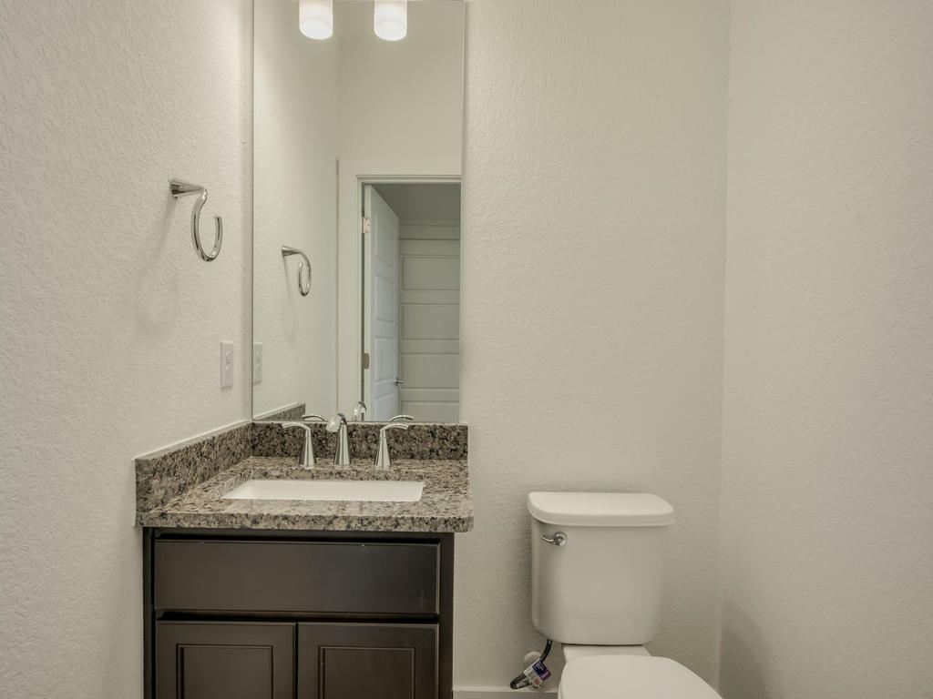 12327 Maypole Bend Austin, TX 78717 - Photo 19 of 30 a bathroom with a granite countertop sink and a toilet