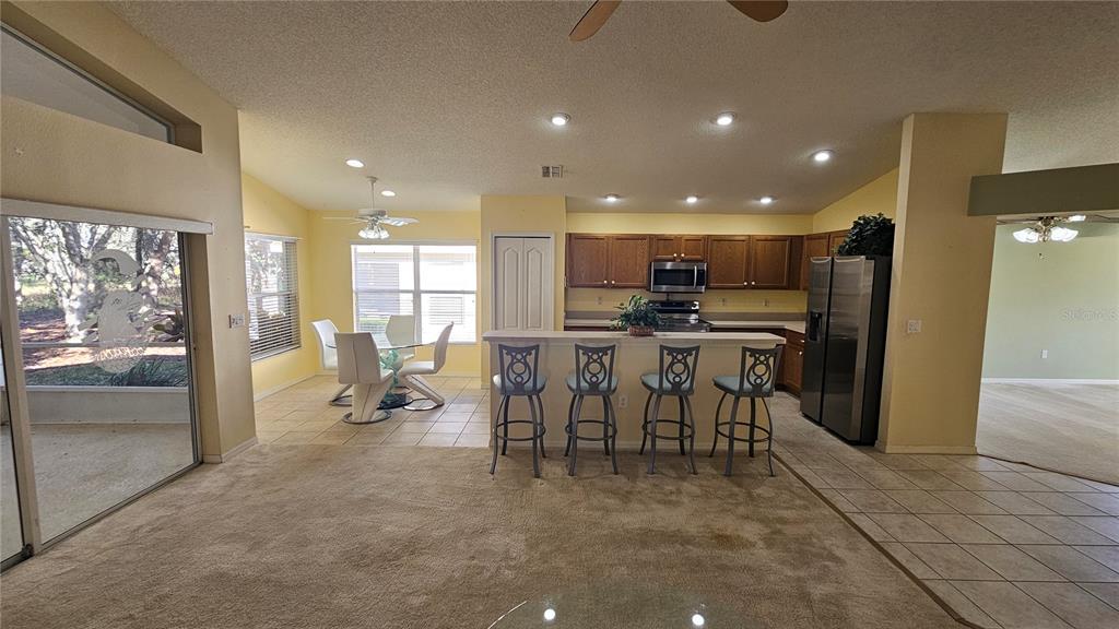 371 Quane Avenue Spring Hill, FL 34609 - Photo 33 of 45 a open kitchen with stainless steel appliances kitchen island granite countertop a refrigerator and a sink