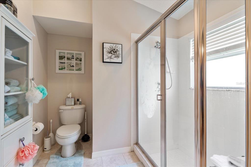 371 Quane Avenue Spring Hill, FL 34609 - Photo 7 of 45 a white toilet sitting next to a bathroom sink