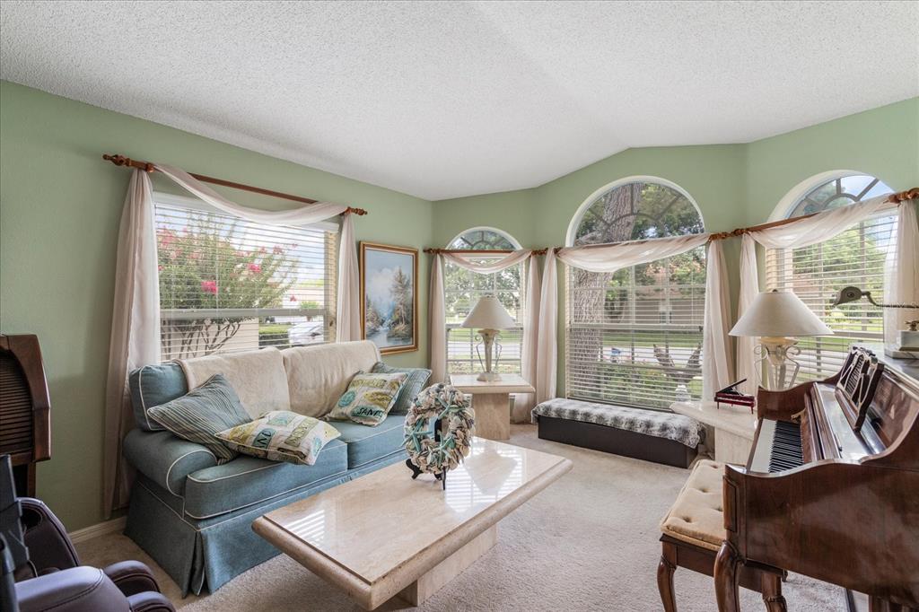 371 Quane Avenue Spring Hill, FL 34609 - Photo 8 of 45 a living room with furniture and a large window