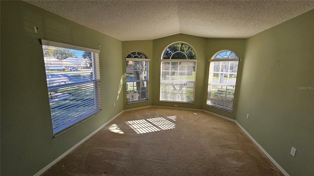371 Quane Avenue Spring Hill, FL 34609 - Photo 9 of 45 a view of an empty room with windows