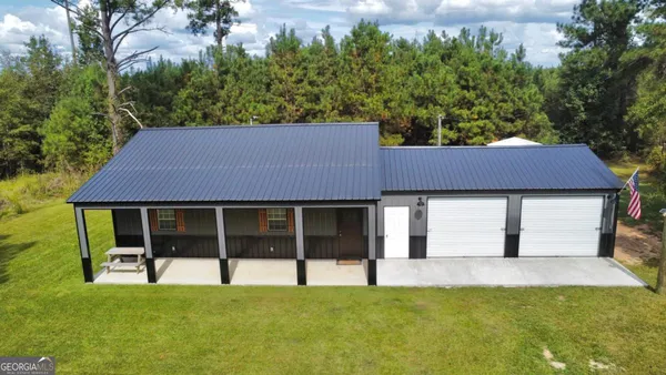 a house that has a big yard with large trees