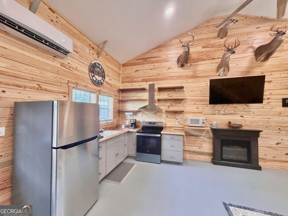 111 Dead River Road Glenwood, GA 30428 - Photo 12 of 39 a kitchen with stainless steel appliances a refrigerator and a stove top oven