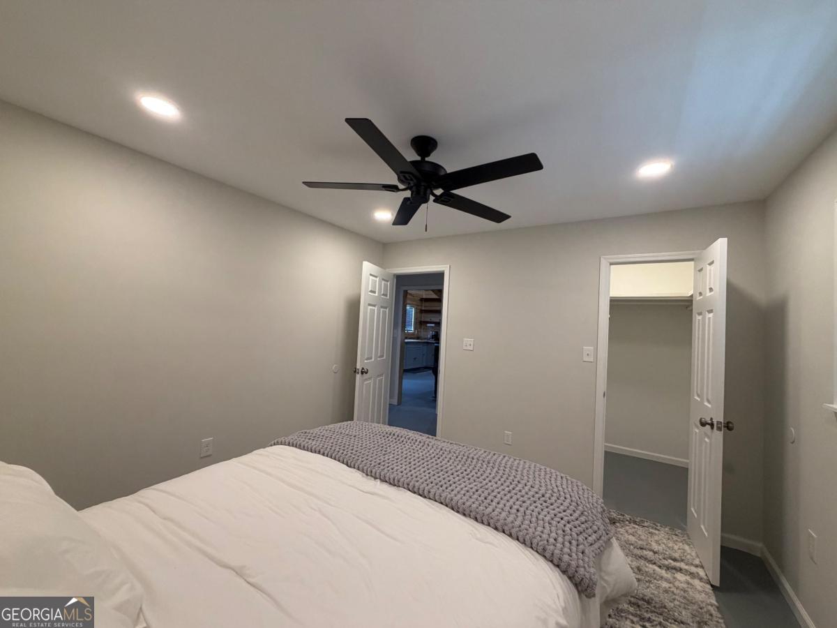 111 Dead River Road Glenwood, GA 30428 - Photo 16 of 39 a bedroom with a bed and a ceiling fan