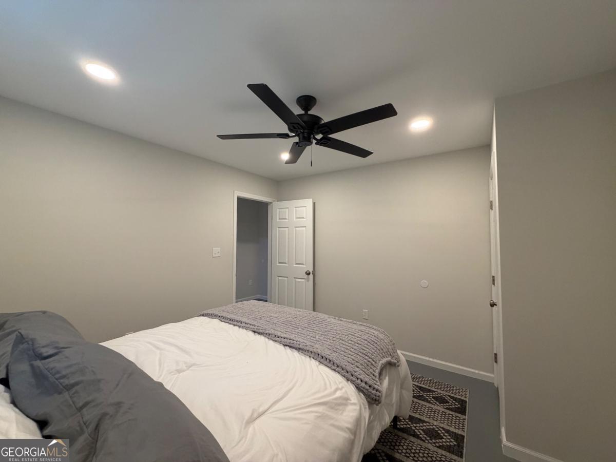111 Dead River Road Glenwood, GA 30428 - Photo 18 of 39 a bedroom with a bed and a ceiling fan