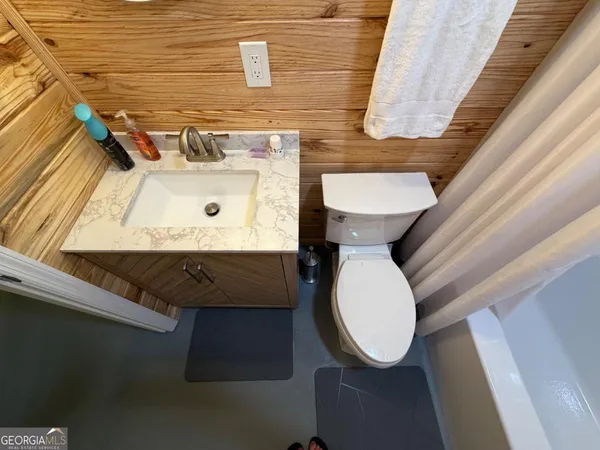 a bedroom with a bed and a rug