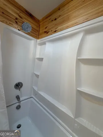 a front view of a house with a garden and yard