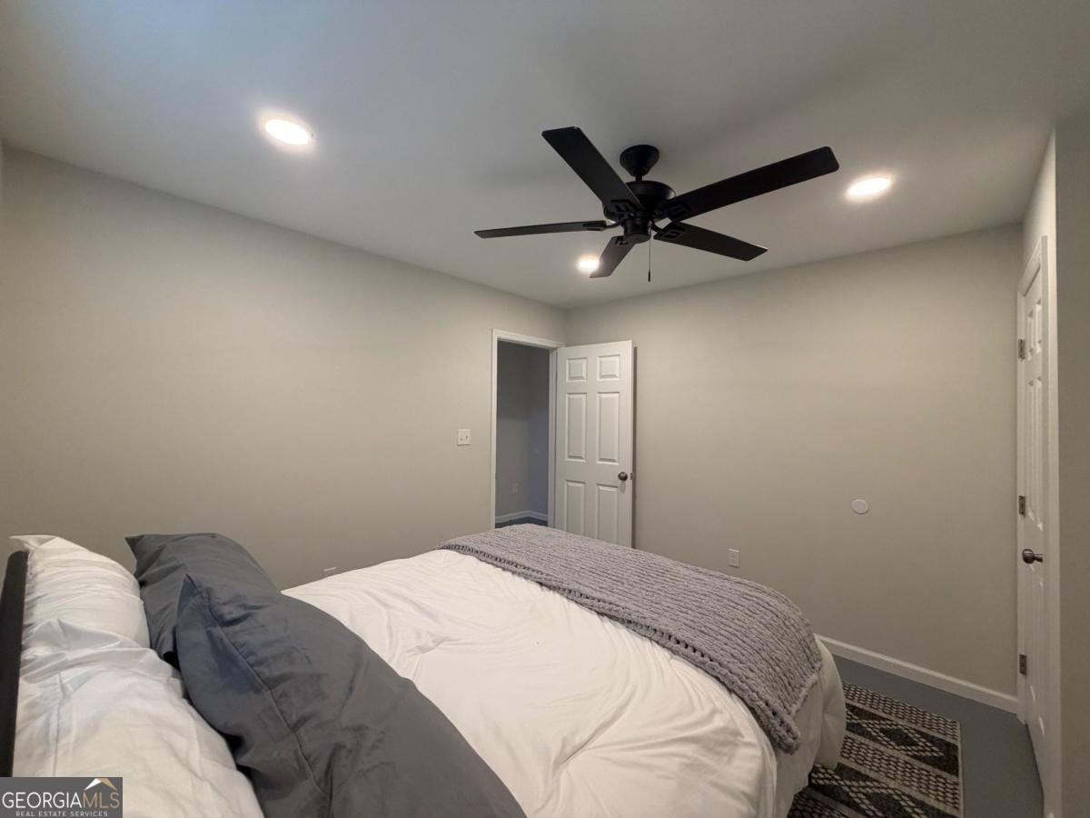 111 Dead River Road Glenwood, GA 30428 - Photo 25 of 40 a bedroom with a bed and a chandelier