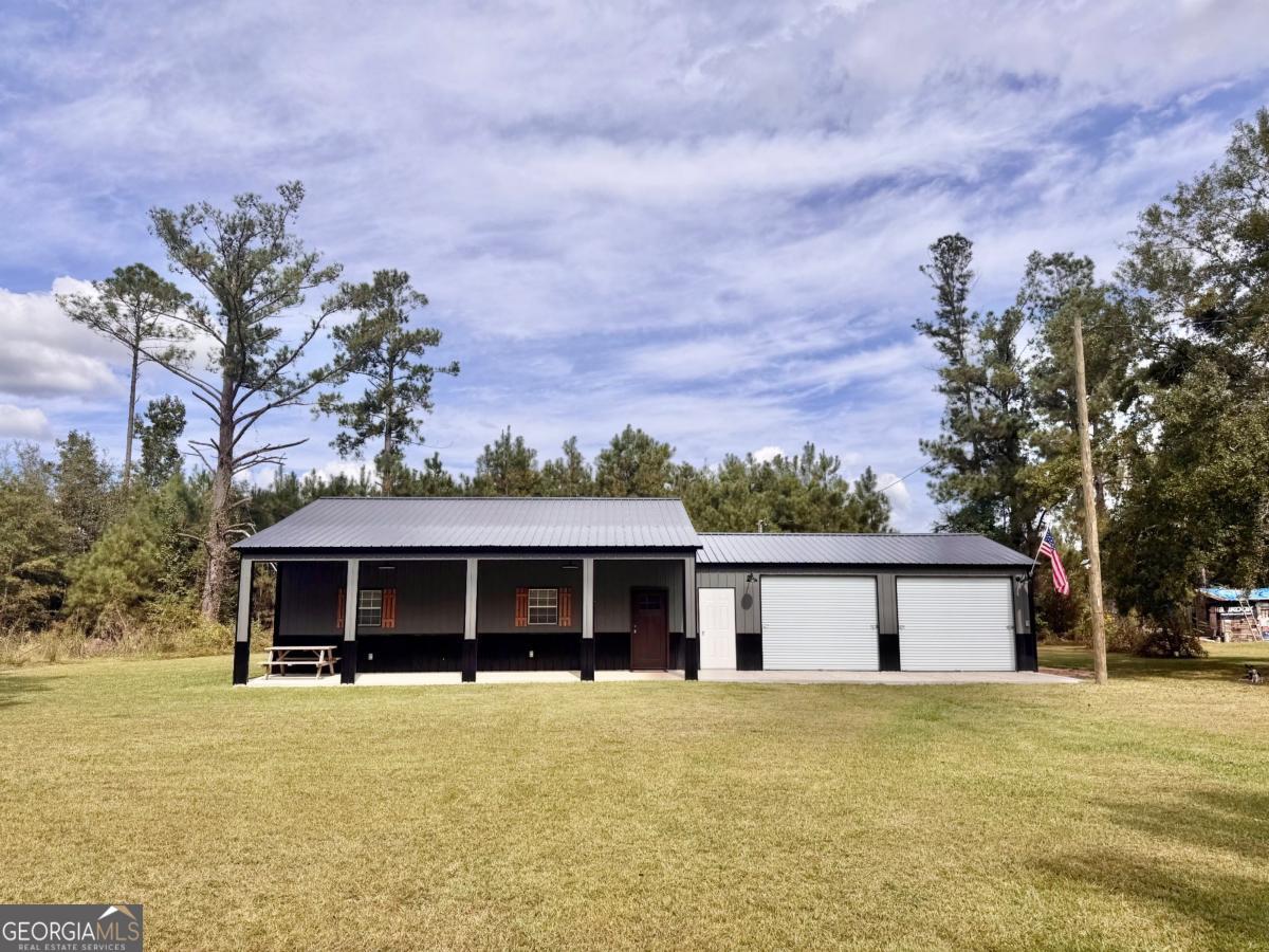 111 Dead River Road Glenwood, GA 30428 - Photo 26 of 40 a front view of a house with a garden and yard