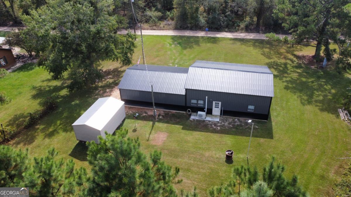 111 Dead River Road Glenwood, GA 30428 - Photo 27 of 39 a view of swimming pool with seating area and trees in the background