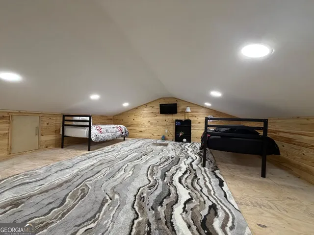 a view of backyard with small cabin and wooden fencing