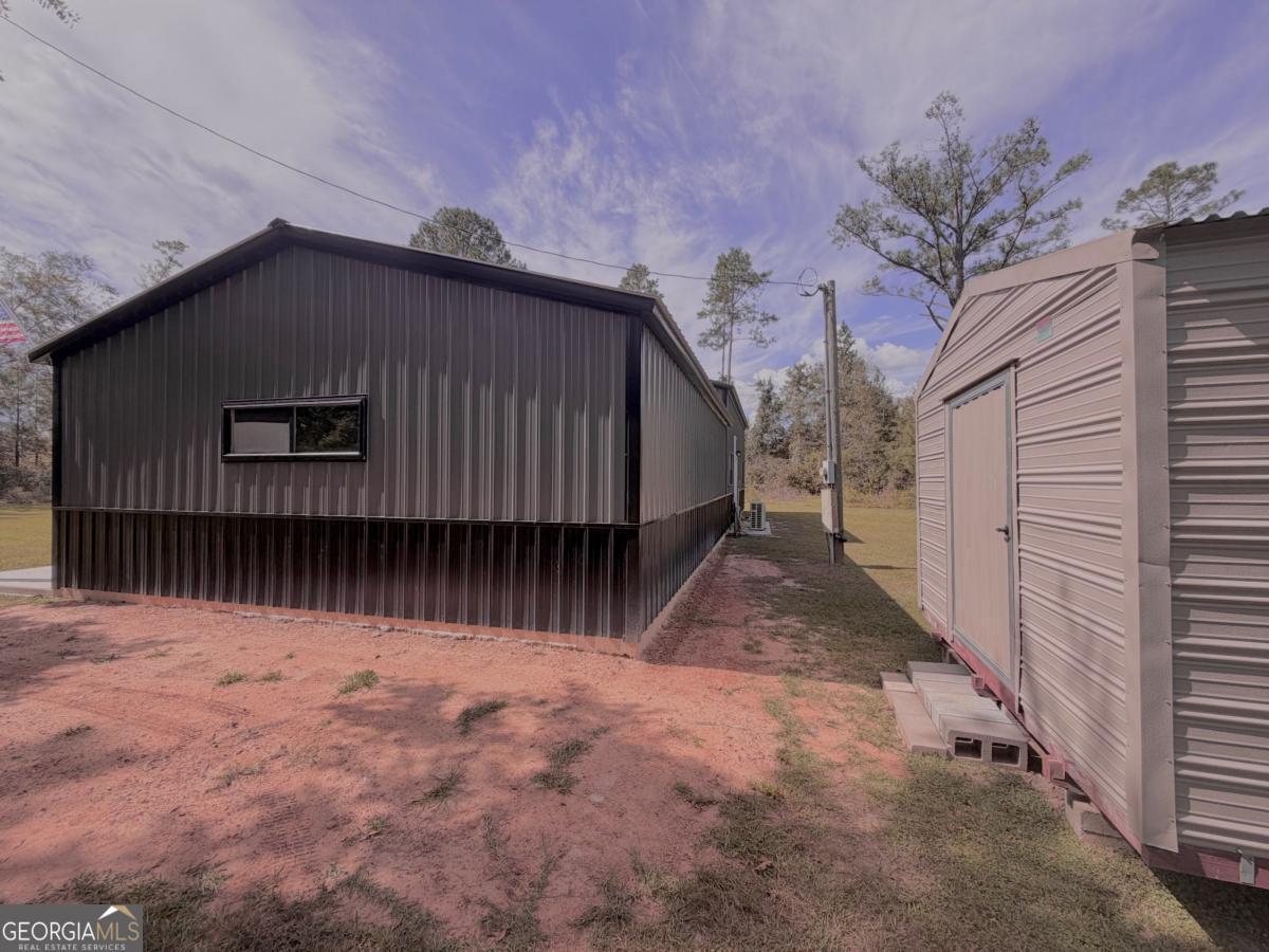 111 Dead River Road Glenwood, GA 30428 - Photo 36 of 39 a view of backyard with small cabin and wooden fencing