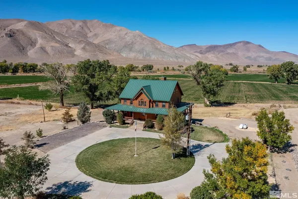 an aerial view of a house with outdoor space swimming pool