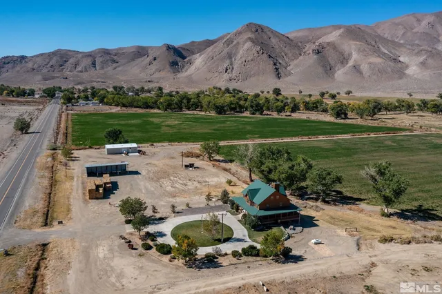 an aerial view of a house with mountain view