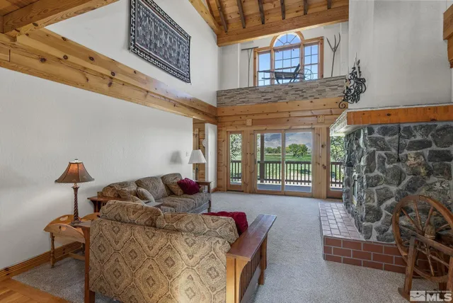 a living room with furniture fireplace and window