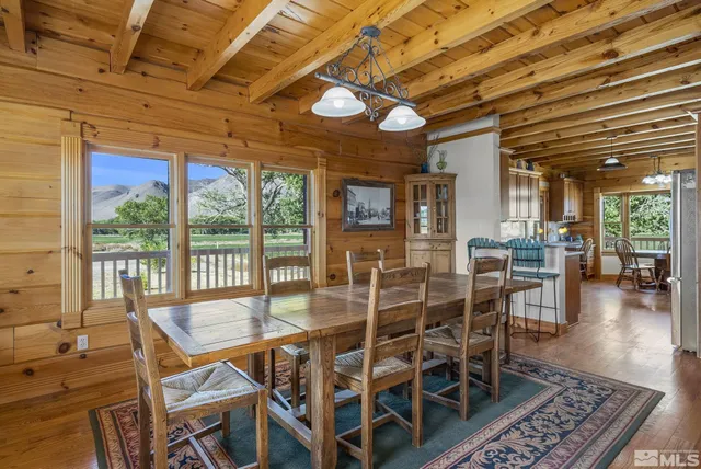 a dining room with furniture a chandelier and wooden floor
