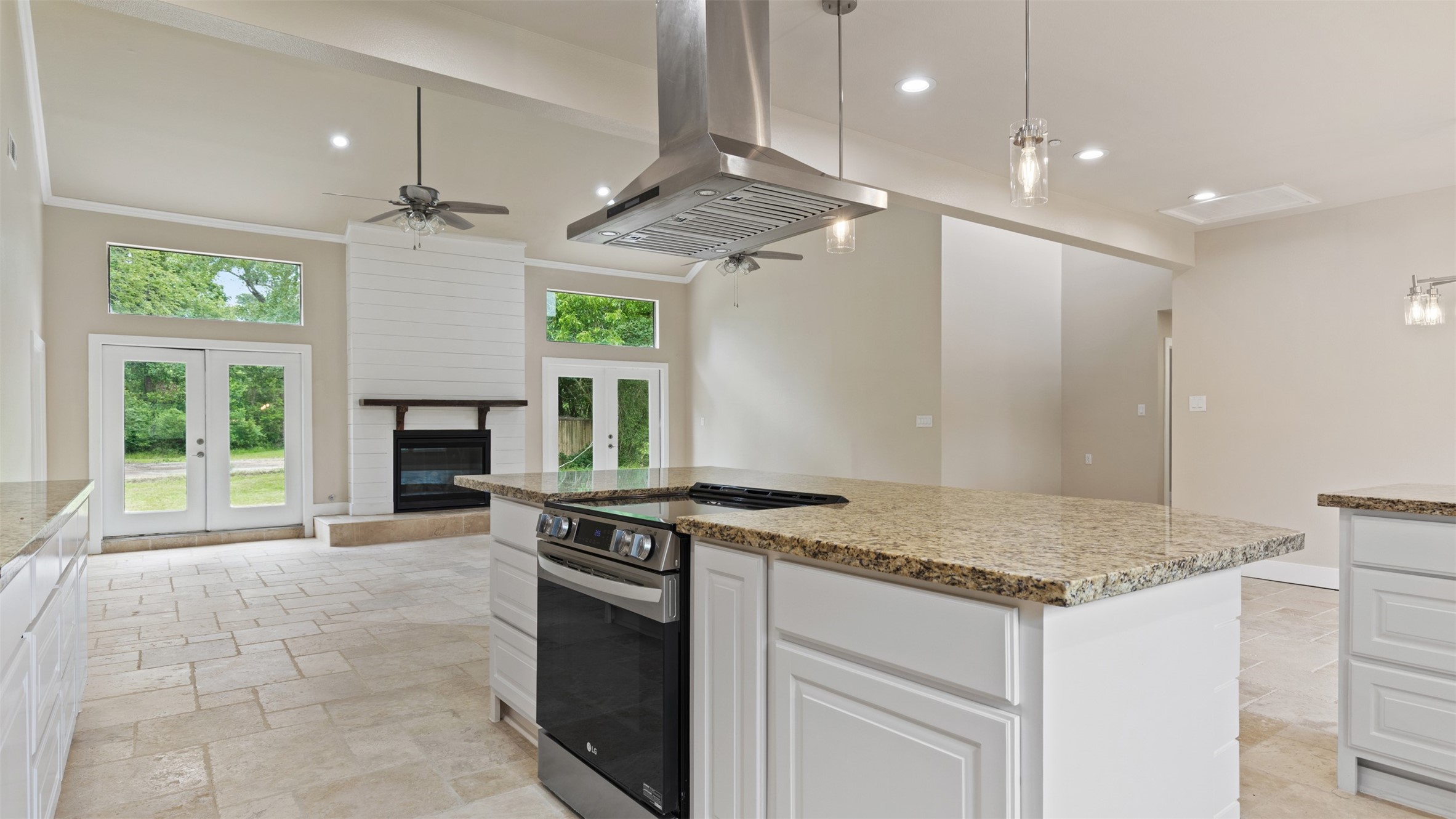 10308 Ehlers Road Conroe, TX 77302 - Photo 4 of 31 a kitchen with a stove a faucet a chandelier and living room view