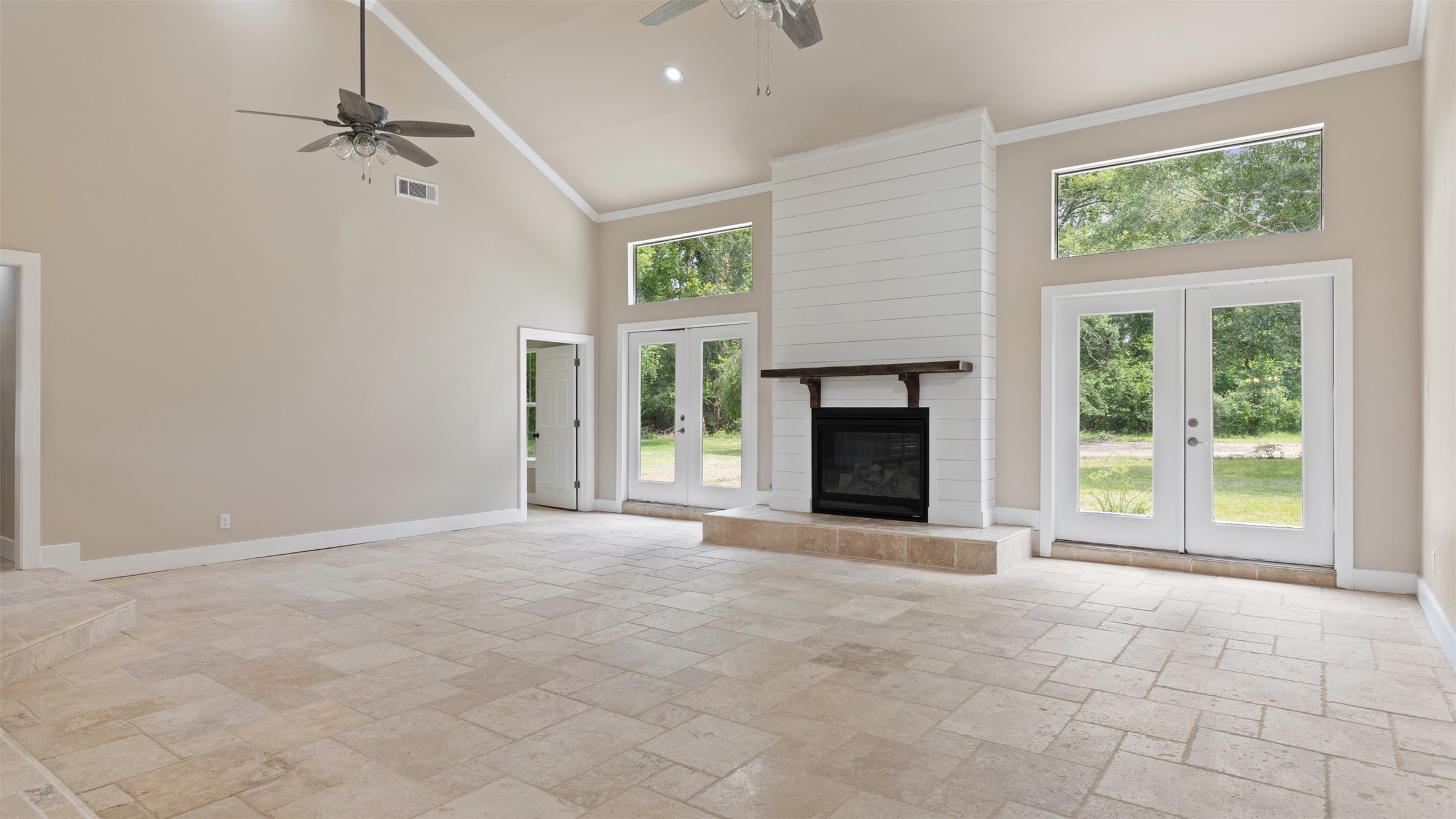 10308 Ehlers Road Conroe, TX 77302 - Photo 10 of 31 an empty room with windows and fireplace