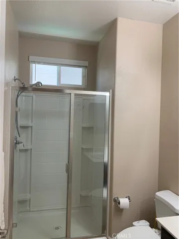 a bathroom with a shower and a toilet