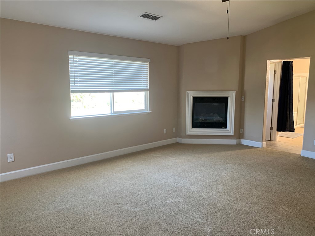 538 Burnt Ranch Way Chico, CA 95973 - Photo 24 of 34 an empty room with windows and fireplace