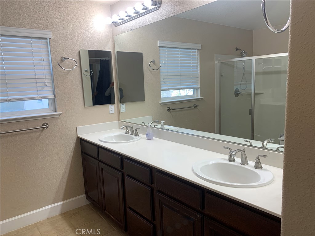 538 Burnt Ranch Way Chico, CA 95973 - Photo 26 of 34 a bathroom with a double vanity sink and a mirror