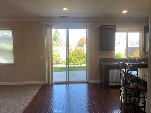 a view of a room with furniture and wooden floor