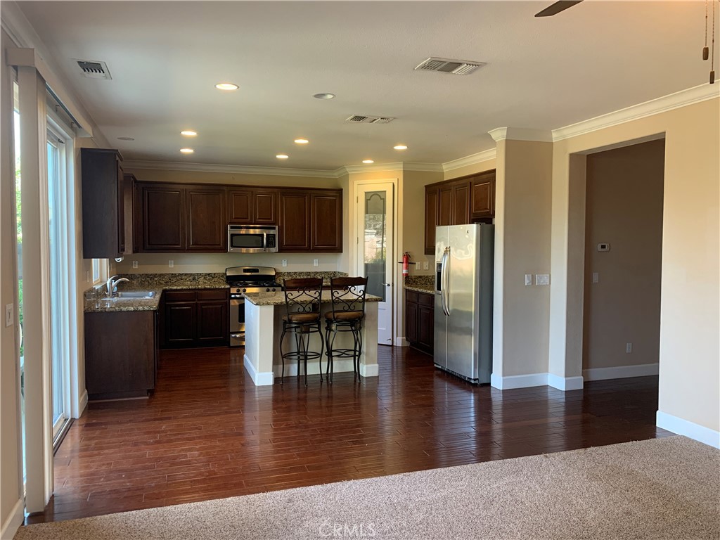 538 Burnt Ranch Way Chico, CA 95973 - Photo 10 of 34 a kitchen with stainless steel appliances granite countertop a refrigerator stove top oven and cabinets