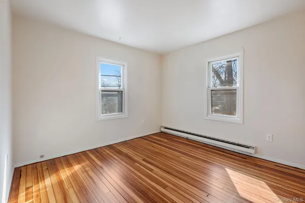 a view of a room with wooden floor and windows