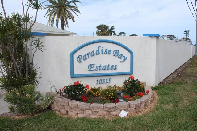 a view of a yard with a table and chairs under an umbrella