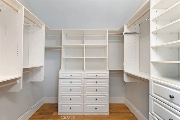 a view of walk in closet with empty racks