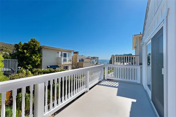 a view of a porch with wooden floor and fence
