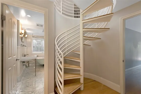 a view of a hallway with wooden floor and entryway